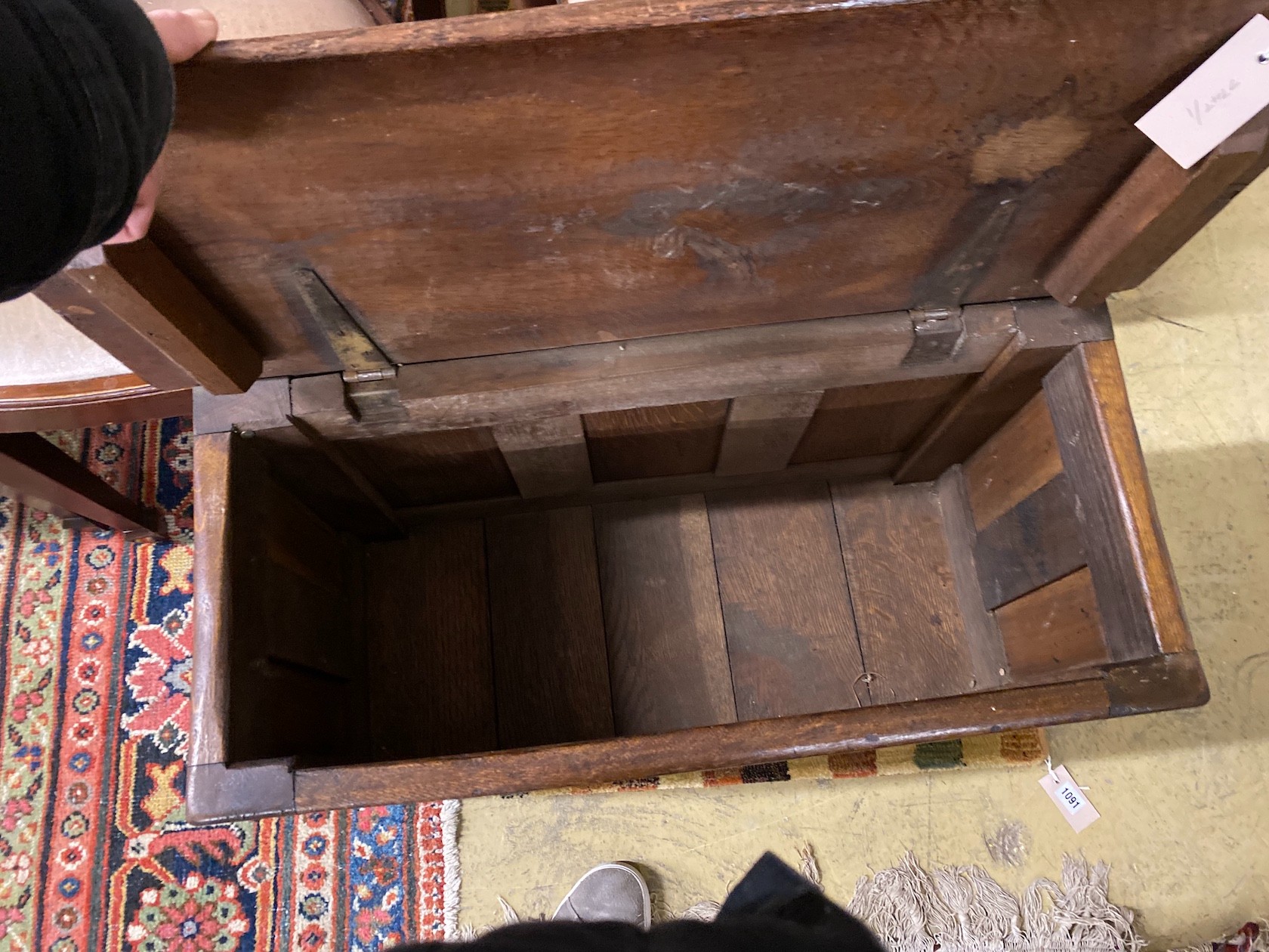 A small 17th century style panelled oak coffer, length 73cm, depth 33cm, height 55cm